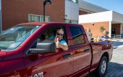 A man gives a thumbs-up from his truck.