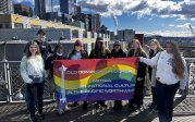 Students posing in the Emerald City with banner.