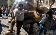 Alonzo Clayton posing with Wall Street Bull