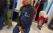 Upward Bound youth strikes a pose in his iFly uniform equipment.