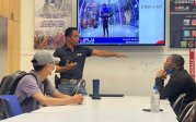 iFly employee gives orientation to Upward Bound youth.