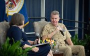 Adm. Samuel Paparo speaks with host Cathy Lewis on stage during the question-and-answer session.