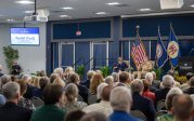 Adm. Samuel Paparo sits on stage while answering a question posed in writing by an audience member.
