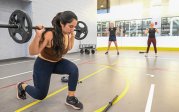 A woman performs lunges.