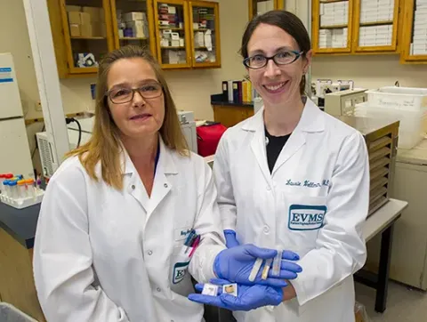 Dr. Laurie Wellman and Mary Ann Clements present specimens i