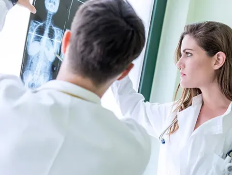 A team of experts inspects an X-ray.