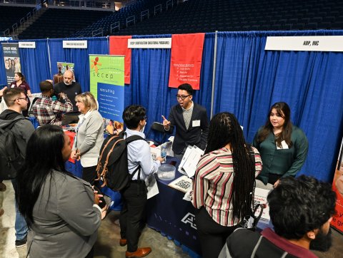 A crowd of students gathered at a career information fair.