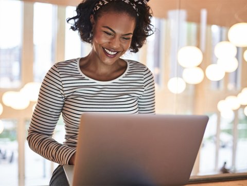 Woman on laptop smiling