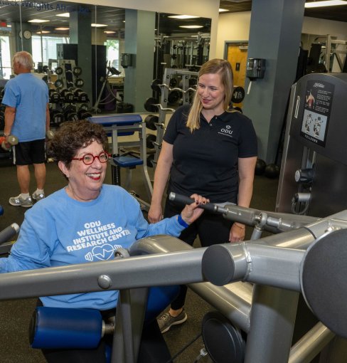Elderly woman exercising on fitness machine