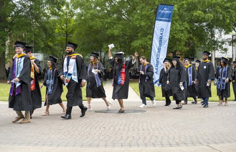 Graduation candidates carry on the tradition of crossing the University seal on their procession to S.B. Ballard Stadium for ODU’s 140th commencement exercises. 
