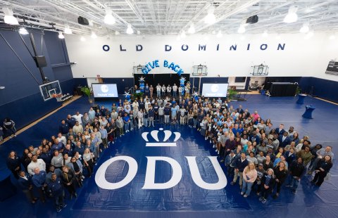 A group of people gathered in a gym.