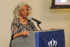 A photo of Cee Cee Tucker speaking at a podium.