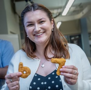 woman holds six and seven chicken nuggets