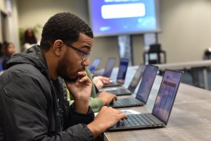 High school student looking at a laptop during class