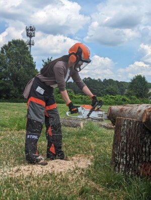 Girl using chainsaw