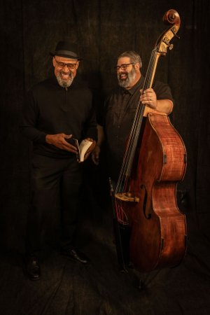 Two men pose with bass violin