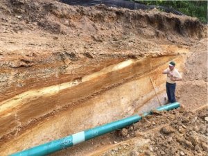 Bob Ganis looks at a layer of sediment.