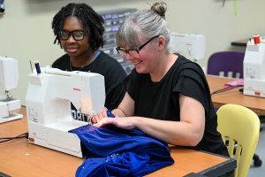 Two women at a sewing machine