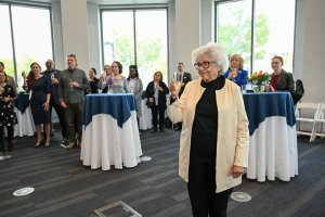 Nina Brown and a crowd make a toast