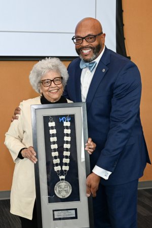 Nina Brown and ODU President Brian O. Hemphill pose with a medallion