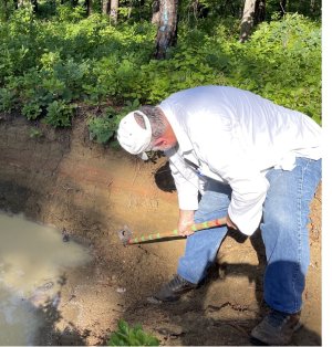 Rich Whittecar examines a layer of sediment.