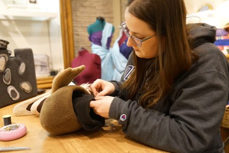 Person sewing a puppet