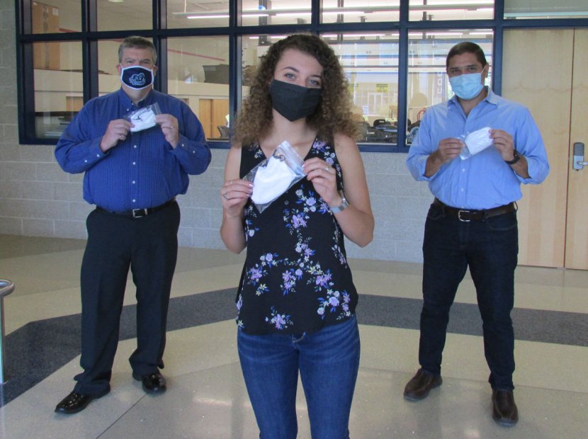 Engineering student Jordan Locklear holding up masks she sew