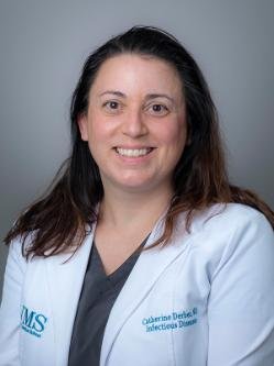 Dr. Catherine Derber is a woman with long dark brown hair, w