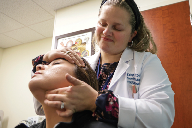 Katelyn Swiader examines a patient in the Voice and Swallowi