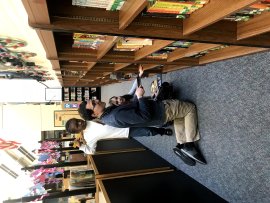 Greg D'Addario in elementary school library with students
