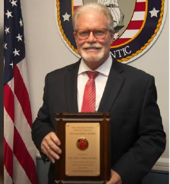 Captain John P. Cordle, U.S. Navy (Retired), receives the 20