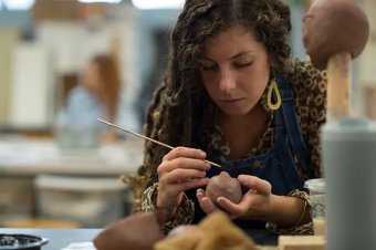 Artist working with clay
